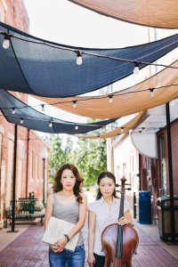 Standing casual outdoor portrait of Phoenix Park-Kim and Kristen Yeon-Ji Yun with cello.