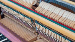 the inside of a piano showing how the key mechanism works
