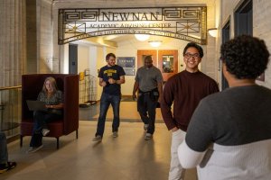 Students and advisors chatting outside of the Newnan Advising Center