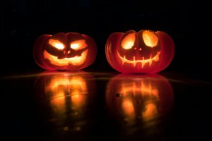 Two glowing Jack-O-Lanterns made from pumpkins.