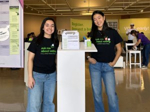 Two UMICH Votes Fellows at the entrance to the Campus Voting Hub at the Duderstadt Center Gallery
