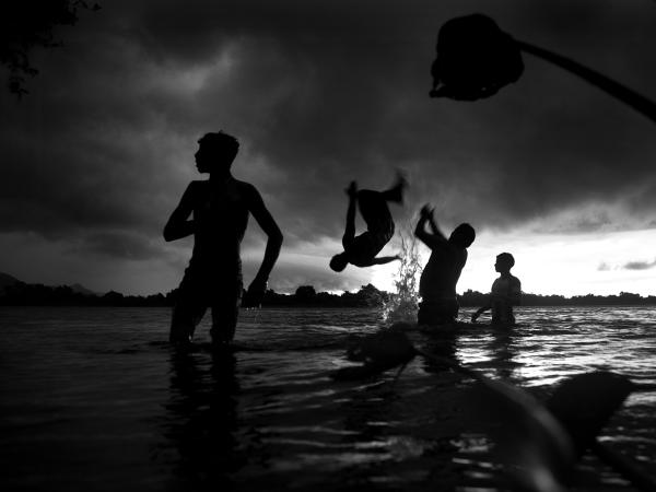 Just before a storm, young men from Barra do Sao Lorenzo go for a refreshing jum