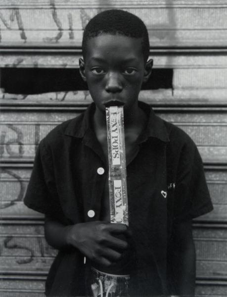 Dawoud Bey, A Boy Eating a Foxy Pop, Brooklyn, NY, 1997, gelatin silver print, U