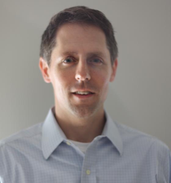 Aaron Colangelo of the NRDC is pictured wearing a crisp, light-blue dress shirt.