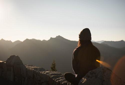 person sitting on a mountain
