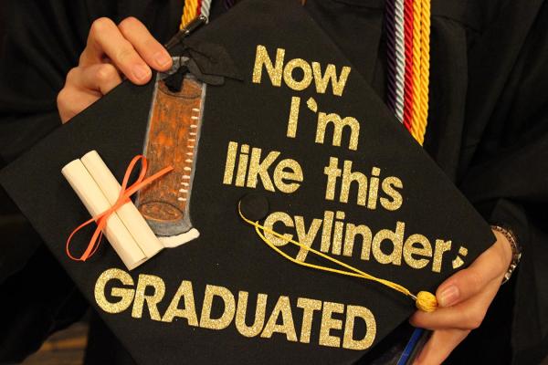 mortar board decorated "now I am like this cylinder --graduated"