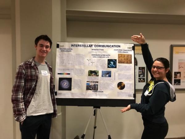 Students Showing Interstellar Communication Poster