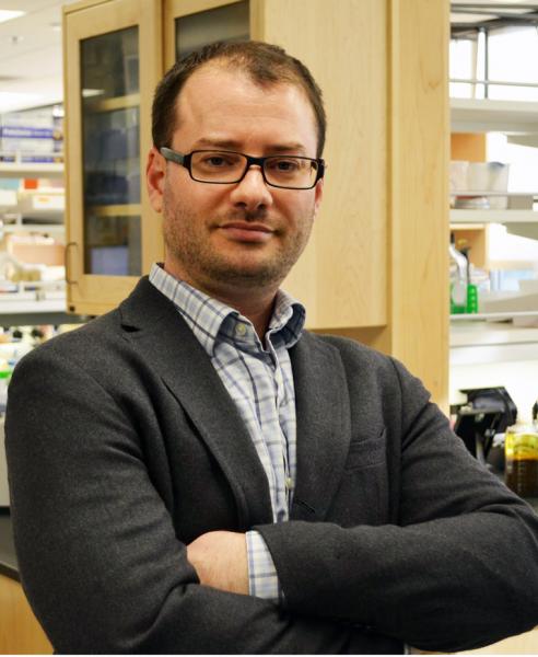 portrait of Dion Dickman, with lab background