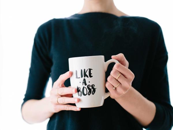 woman holding coffee mug that says "Like a Boss"