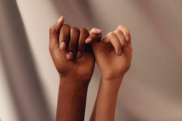 Hands linking pinky fingers
