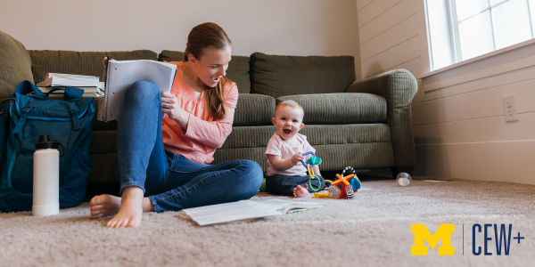 Woman studying on floor, with child next to her