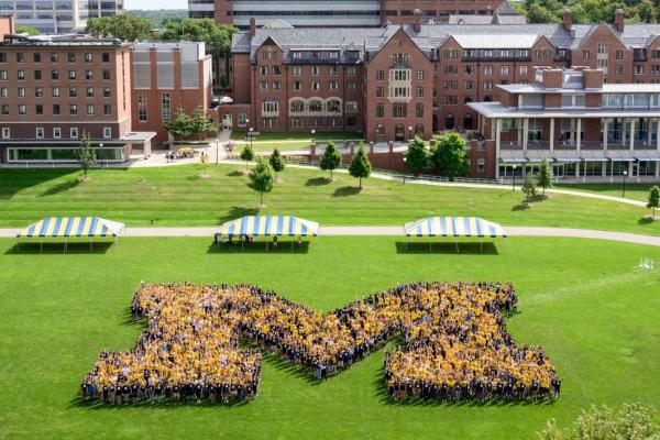 Group of students in the shape of a Block M on Palmer Field