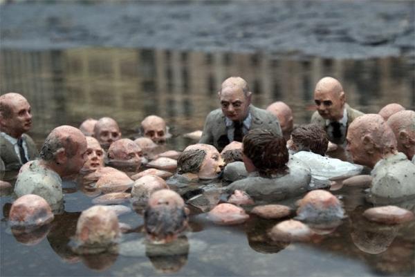 Sculpture by Isaac Cordal, colloquially known as “Politicians discussing global warming"
