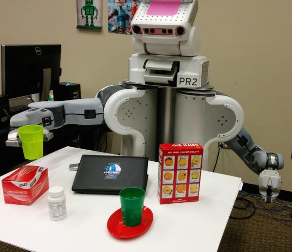 A robot manipulation objects on a table