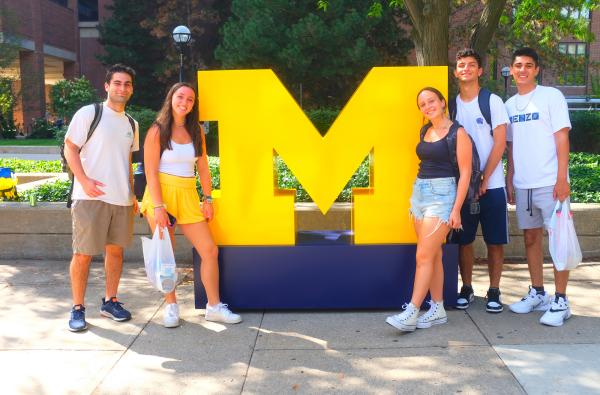 Students in front of a block M.