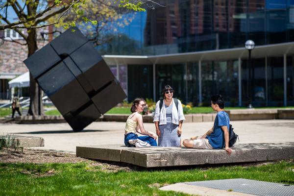 Students in front of Cube sculpture