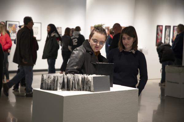 People looking at students artwork
