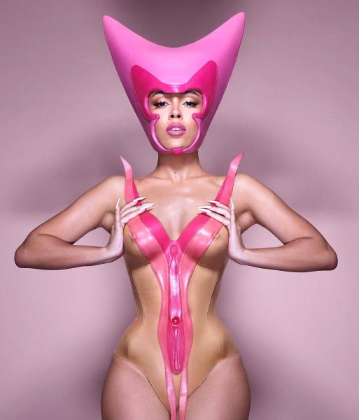 Doja Cat wears a pink headpiece and bustier