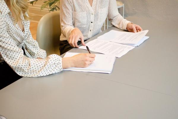 Two people negotiating a contract.