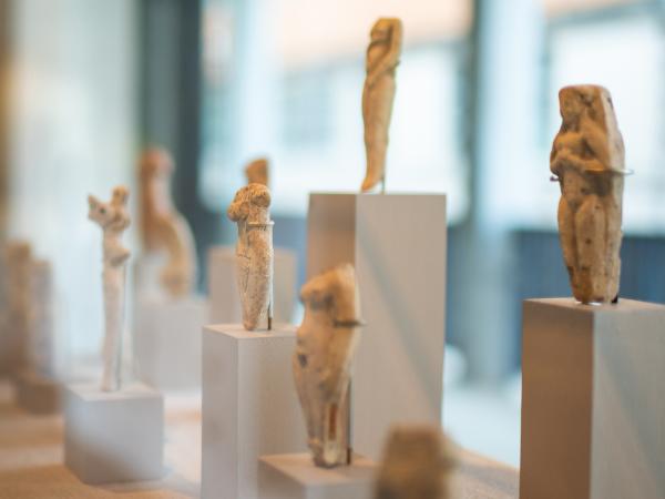 Kelsey Museum display showing a grouping of stone nude goddess sculptures.