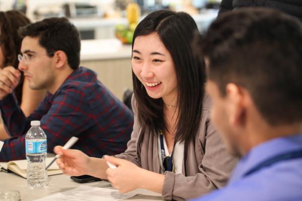 Two students smile while chatting at a CFE event.