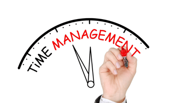 Image of a hand on a clock with the words "Time Management"