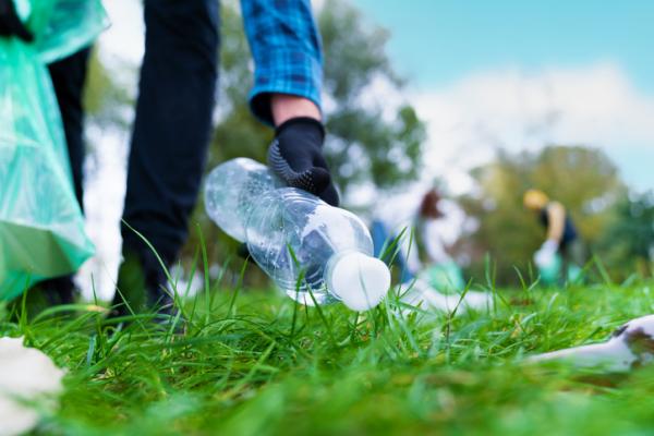 Picking up a plastic water bottle