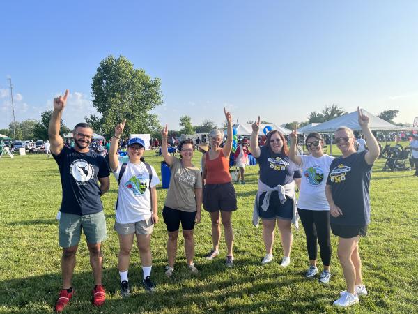 A group of individuals holding up one finger.