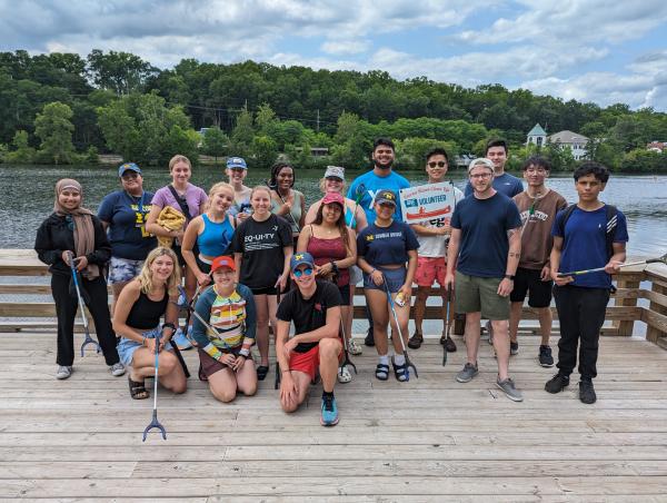 Planet Blue Ambassadors pose in front of the river following a canoe clean-up