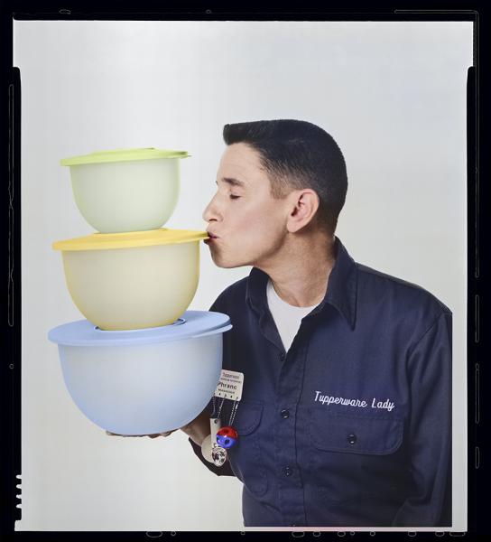 Artist Phranc kissing a stack of Tupperware containers