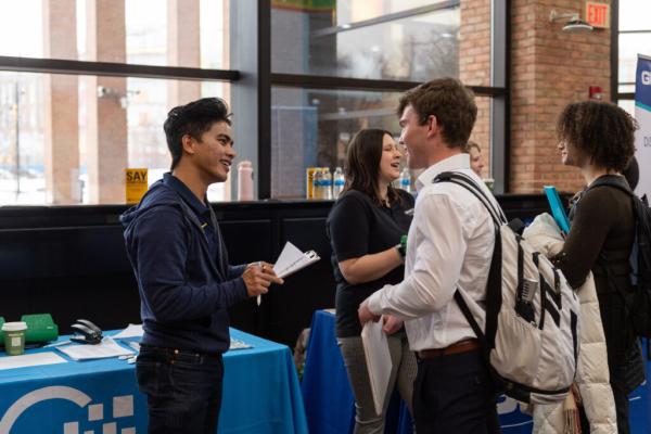 Image of a student networking with a recruiter.