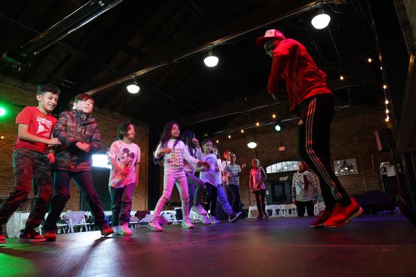 Kids dancing at the Ypsilanti Freighthouse during a UMS presentation of a breakdancing workshop.