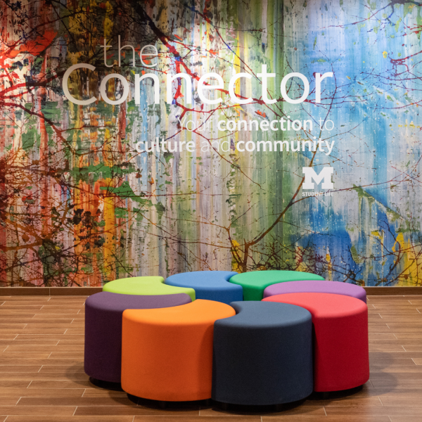Colorful wall that reads "The Connector" in back of it.