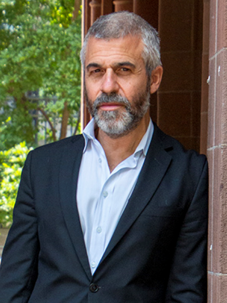 Photo of Professor Jonathan Kramnick leaning against a wall outdoors.