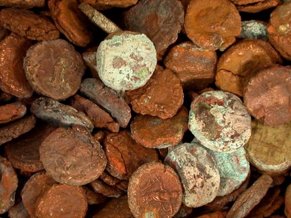 Close-up of a hoard of heavily corroded copper and billon coins from Karanis.
