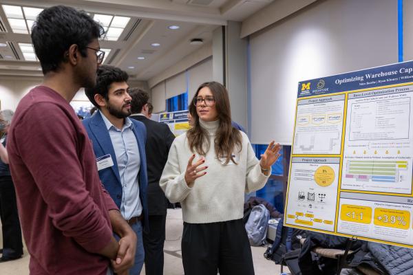 A person presents research poster