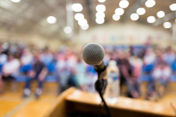 Microphone in focus with attendees blurred out