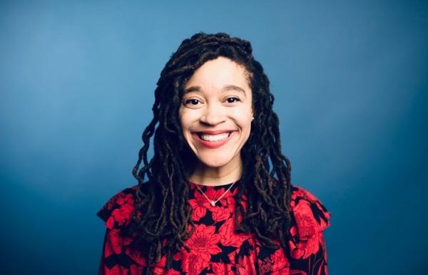 Headshot of Dr. Cureton from the shoulders up, smiling in a red floral blouse.