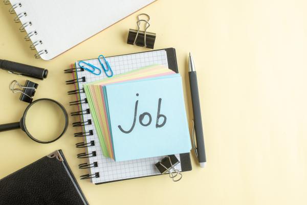 Pile of office supplies with word 'job' written on top