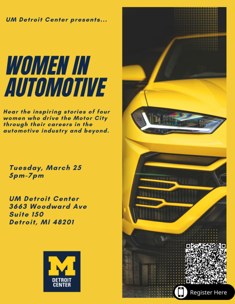 Frontal view of a yellow vehicle's windshield, headlight, and grill.