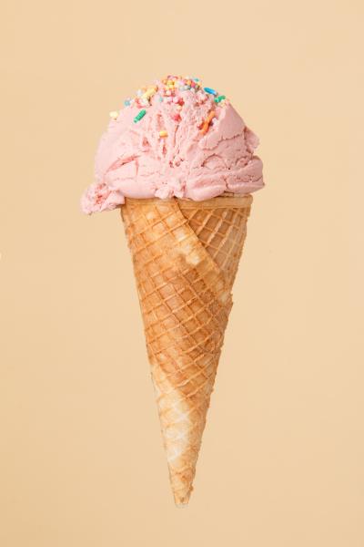 Ice cream cone with strawberry ice cream and sprinkles