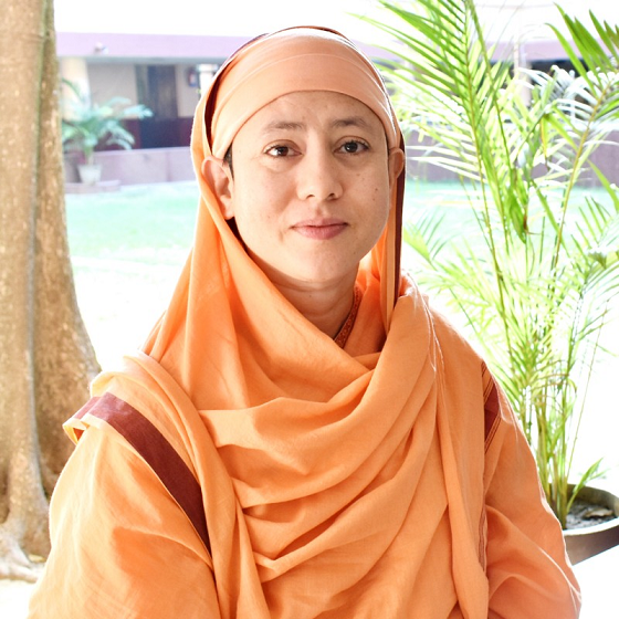 The image features the speaker, Pr. Divyanandaprana dressed in the attire of a traditional Hindu nun/monastic. There are plants in the background.