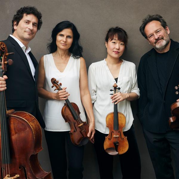 Belcea Quartet against gray background holding their instruments
