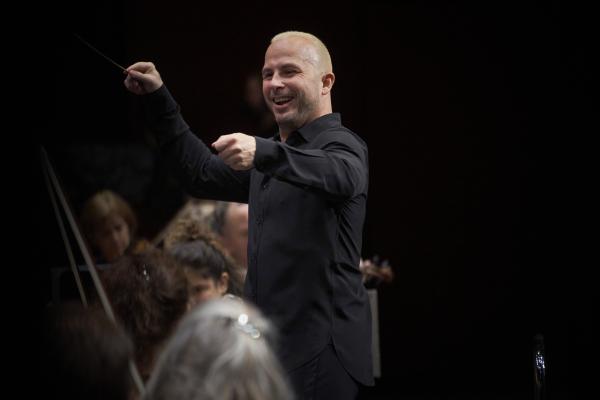 Conductor smiles while conducting