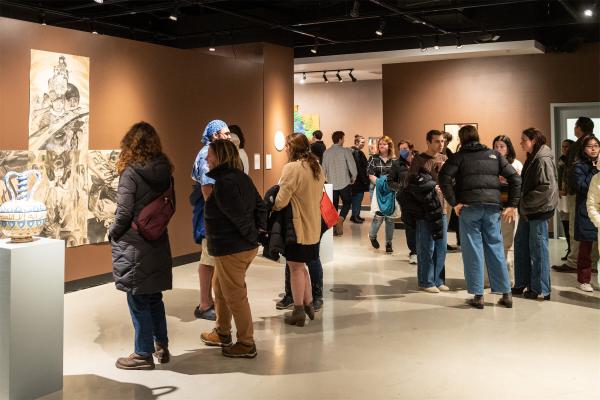 Gallery visitors look at work at an exhibition