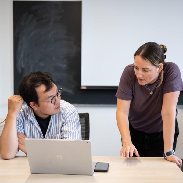 An instructor and student chatting