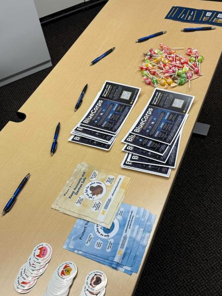 Table with BlueCorps handouts, candy, and pens
