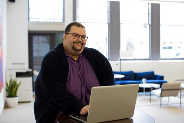 Tall man in a bright, open office