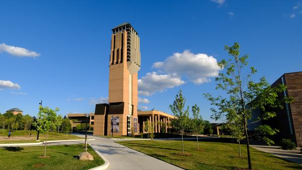 Carillon with blue sky and white clouds, green grass, trees