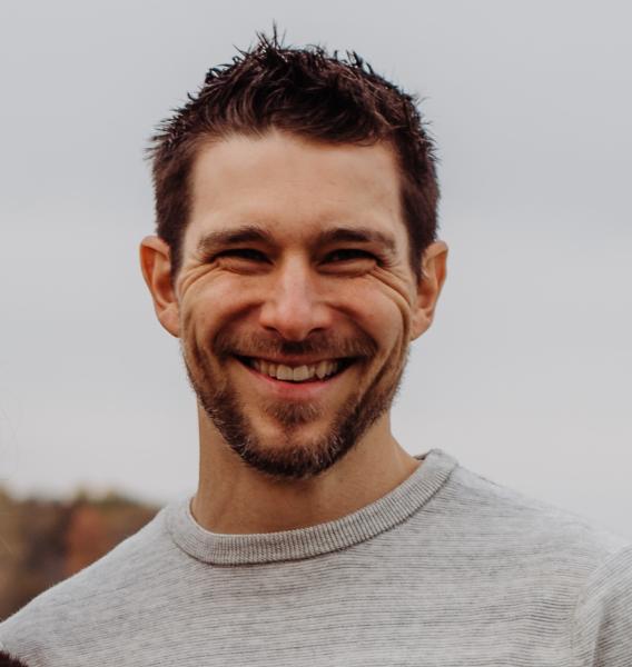 Adam Reimer headshot: white man with short dark brown hair and beard.